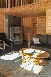 a living room with a couch and a coffee table at Holiday Home Antin mökki by Interhome in Ylikyro