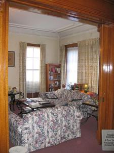 a living room with a couch and a table at Olde Judge Mansion B&B in Troy