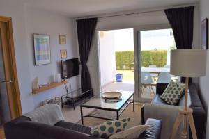 a living room with two couches and a tv at Ground Floor with private garden Bellresguard in Port de Pollensa