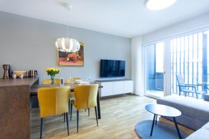 a dining room and living room with a table and chairs at Apartments Poklukar Bled in Bled