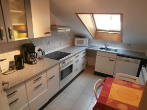 a kitchen with a sink and a stove top oven at schöne Wohnung für 1-4 Gäste in Ostfildern