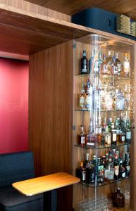 a wooden shelf filled with bottles and bottles at Hotel Beethoven Wien in Vienna