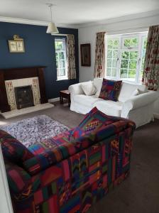 a living room with a couch and a fireplace at Old Telephone Exchange in North Thoresby