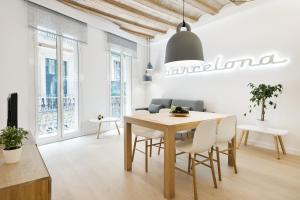 a kitchen with a table and chairs and a large window at Ola Living Santa Anna in Barcelona