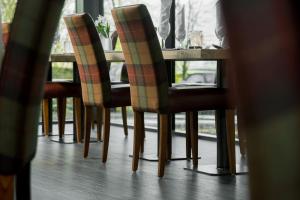 a dining room table with chairs and chairs at Stone House Hotel in Hawes