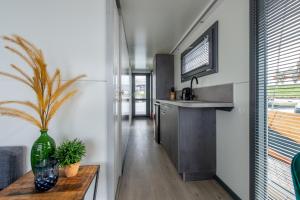 a living room with a table and a kitchen at Waterlodges Veerse Meer in Kamperland