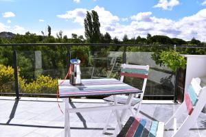 a table and two chairs sitting on a balcony at ALBERGUE HOSTING DUERO in Pesquera de Duero