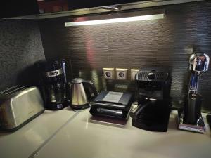 a counter with a coffee maker and a toaster and a coffee pot at Villa Iris in Livadi