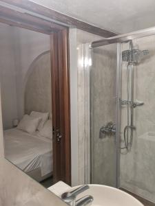 a bathroom with a shower with a bed and a sink at Relax Seaside House by living in blue in Haraki +92 photos