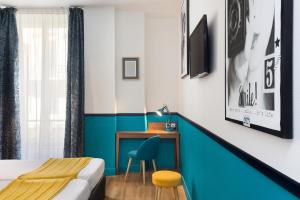 a hotel room with a bed and a desk at Hotel Nap By HappyCulture in Nice
