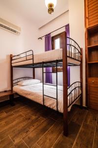 two bunk beds in a room with wooden floors at Casa Del Fantino in Chania