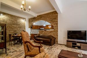 a living room with a couch and a tv at Casa Del Fantino in Chania