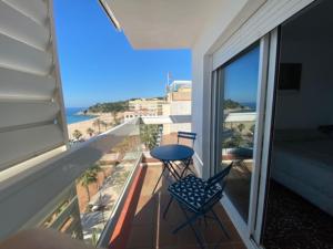 a balcony with a table and chairs and a view of the ocean at Mediterranean apartment in Lloret de Mar next to the Sea in Lloret de Mar