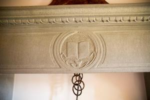 a ceiling with a carving of a book on it at La Renaia in Cortona