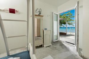 a room with a door leading to the ocean at Boccatura in Skala Kallirachis