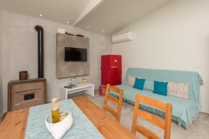 a living room with a couch and a table at Boccatura in Skala Kallirachis