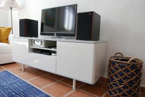 a living room with a tv on a white entertainment center at LA CIGALE by K6 Conciergerie Prestige in Cassis