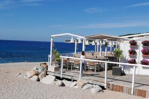 a woman sitting at a restaurant on the beach at LA CIGALE by K6 Conciergerie Prestige in Cassis