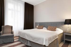 Postel nebo postele na pokoji v ubytování Elite Hotel Savoy
