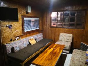 a living room with a couch and a table at Holiday Home Dragon in Visoko