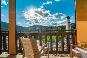 a chair on a balcony with a view at F&B Spa Resort (ex. Fomich Hotel) in Bukovel +288 photos
