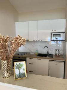 a kitchen with a picture of a palm tree on a counter at Villa Orca in Podaca