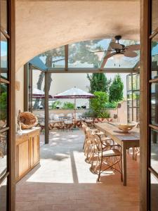 a dining room with a table and chairs and a patio at La Bionda Hotel - Adults Only in Begur