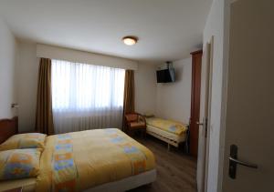 En eller flere senge i et værelse på Hotel Du Quai
