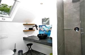 a bathroom with a sink and a shower at Schacht34 in Oberhausen