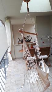a white hammock hanging from a ceiling in a room at "CASABANA" - relax tutto l'anno - giardino - piscina Top in Malcesine
