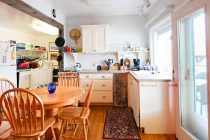 a kitchen with a wooden table and a table and chairs at Fairhaven in Pulteney