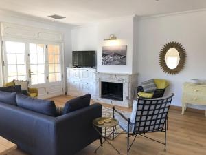 a living room with a couch and a fireplace at Villa Anna in Begur
