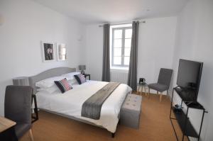 a bedroom with a bed and a flat screen tv at Les Tourelles in Biarritz