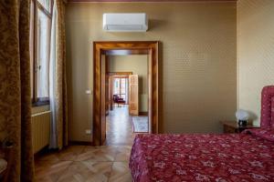 a bedroom with a red bed and a hallway at Giglio Suite 2476 in Venice