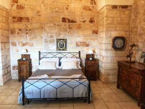 a bedroom with a bed and two night stands at Masseria Scianne in Sant'Isidoro