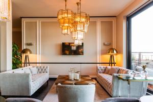 a living room with couches and a table at C-Hotels Andromeda in Ostend