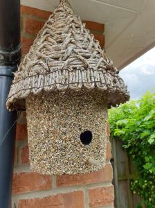 a bird feeder on the side of a building at Old Telephone Exchange in North Thoresby