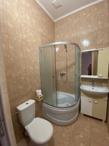 a bathroom with a shower and a toilet and a sink at Людмила in Chornomorsk