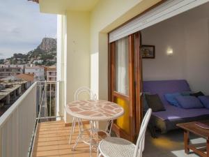 a balcony with a table and a couch and a bed at PORT III Sistach Rentals in L'Estartit