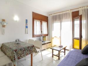 a living room with a table and a bedroom at PORT III Sistach Rentals in L'Estartit