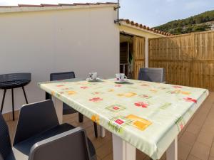 a table with a table cloth on it with chairs at PORT III Sistach Rentals in L'Estartit +15 photos