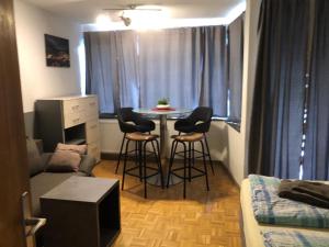 a living room with a table and chairs in a room at Haus Alpenkönig Top 17 in Bad Gastein