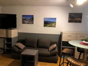 a living room with a couch and a table at Haus Alpenkönig Top 17 in Bad Gastein