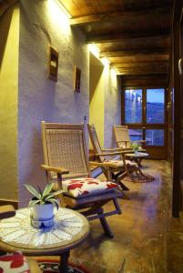 a group of chairs and tables in a room at Posada El Mirador in Lavín