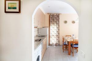 a kitchen with a table and a dining room at PORT I Sistach Rentals in L'Estartit +14 photos