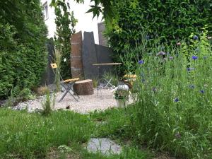 a garden with a table and chairs and flowers at Villa Modern in Ufhusen