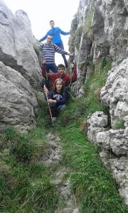 a group of people hiking up a rocky mountain at Posada El Mirador in Lavín