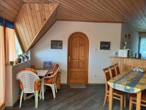 a kitchen and dining room with a table and chairs at Hévízi fecskefészek in Hévíz