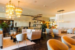 a lobby with couches and chairs and a table at C-Hotels Andromeda in Ostend