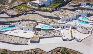 an aerial view of a resort with two swimming pools at Aregou Villas in Imerovigli